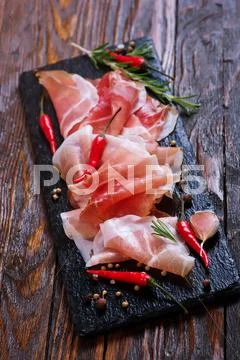 Bacon with spice on the black board Stock Photos