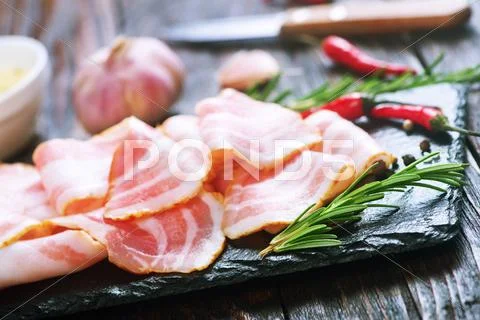Bacon with spice on the black board Stock Photos