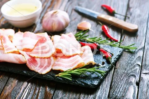 Bacon with spice on the black board Stock Photos