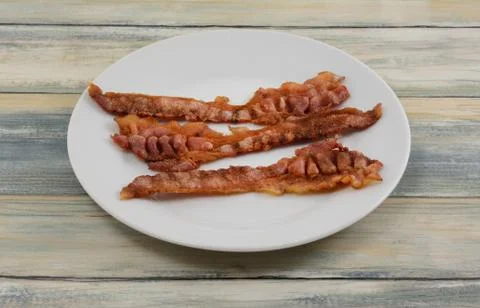Bacon stips on plate Foto stock