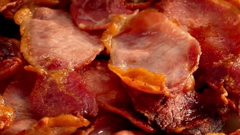 Bacon strips being cooked for breakfast. A pile of Fried bacon slices, closeup. 스톡 동영상 334641844