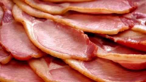 Bacon strips being cooked for breakfast. A pile of Fried bacon slices, closeup. 스톡 동영상 334641863