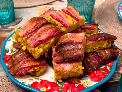 Bacon-Topped Cornbread Casserole Bars on Floral Plate Stock Photos