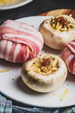 Bacon-wrapped button mushrooms stuffed with cheese Stock Photos