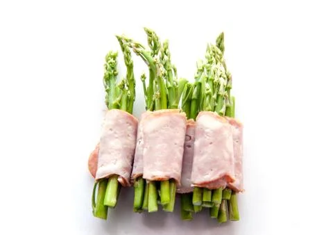 Bacon wrapping asparagus on isolate Фото