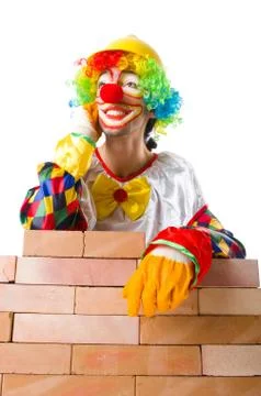 Bad construction concept with clown laying bricks 스톡 사진