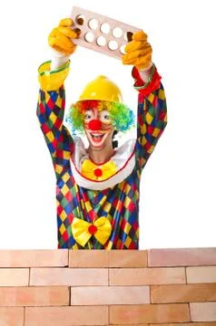 Bad construction concept with clown laying bricks Foto stock
