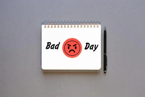 Bad day and grumpy red smiley face icon on notepad. Concept Stock Photos