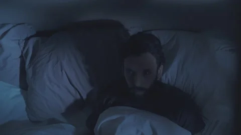 Bad dream night terror scared man nightmare in bed Stock Footage 153664433