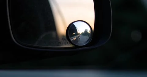 Bad evening road with potholes visible through the right side mirror Stock Footage 337936569