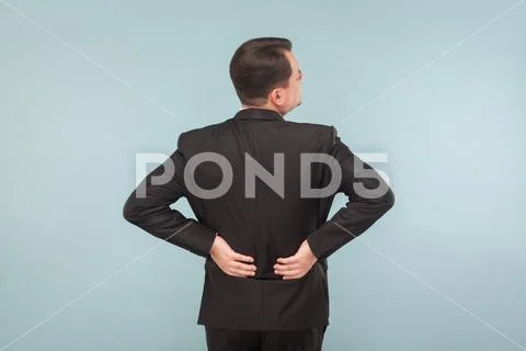 Bad feelings concept. Businessman have back, spine pain Stock Photos