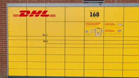 Bad Hersfeld, Germany, 03.02.25. A bright yellow DHL self-service post station Stock Footage 303633854
