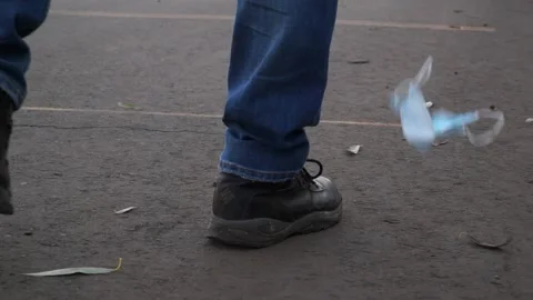 A bad man throws garbage in the forest, in the Park. disposable masks Stock Footage 142230632