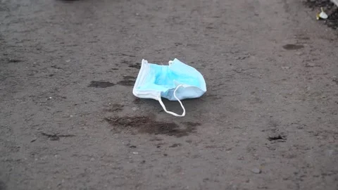 A bad man throws garbage in the forest, in the Park. disposable masks Stock Footage 142230705