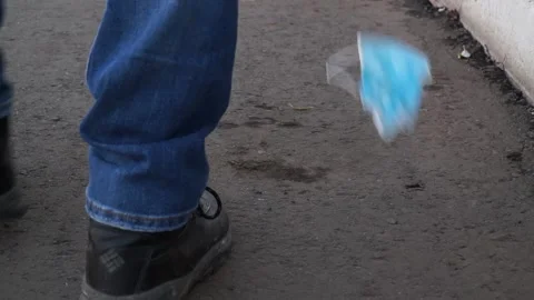 A bad man throws garbage in the forest, in the Park. disposable masks Stock Footage 142230728