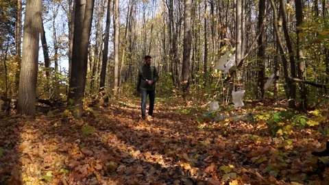 Bad man throws plastic trash in the woods Stock Footage 141898927