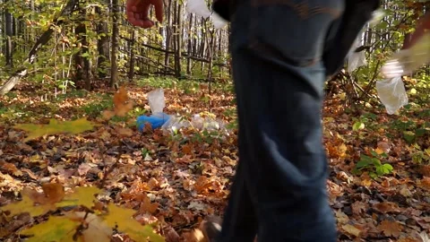Bad man throws plastic trash in the woods Stock Footage 141899085