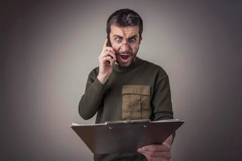 Bad or wrong invoice, young man yelling at his phone Foto stock