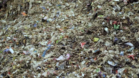 Bad quality organic waste polluted with plastic garbage. waste management plant Stock Footage 232172170