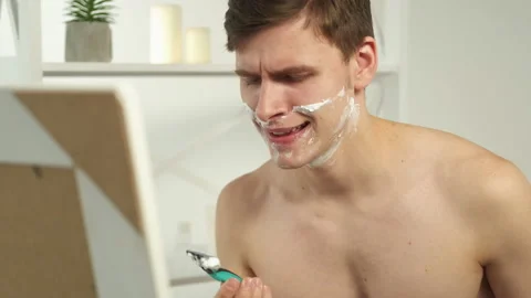 Bad razor shaving problem man bathroom mirror Stock Footage 170385928