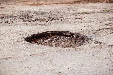 Bad road with deep pit. Problem drivers. Stock Photos