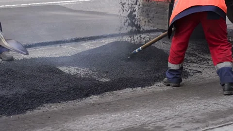Bad road. Roller and workers on asphalting and repair of city streets. Stock Footage 120228633