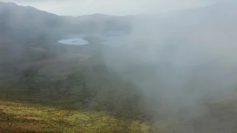 Bad visibility in the cloud above Caldeirao. Green slopes and lakes of Corvo Stock Footage 117306318