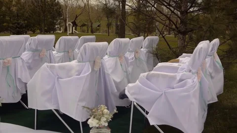 Bad windy weather at the time of the wedding ceremony.White wooden chairs Stock Footage 75883542