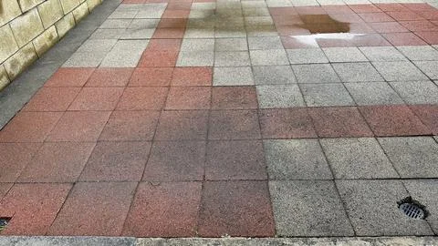 Bad workmanship on a brick patio leaving puddles Stock Photos