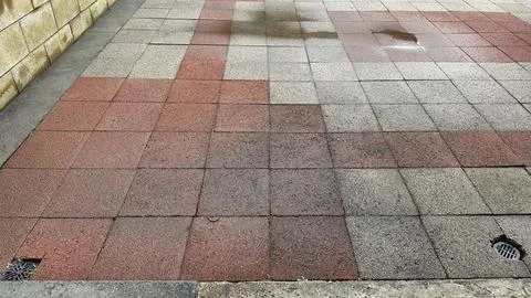 Bad workmanship on a brick patio Stock Photos
