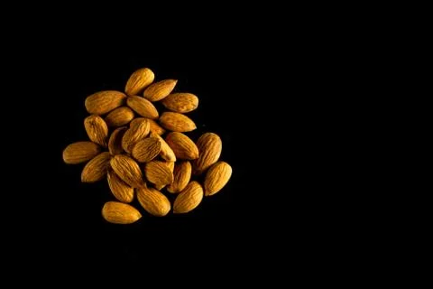 Badam spread out on a dark table Stock Photos