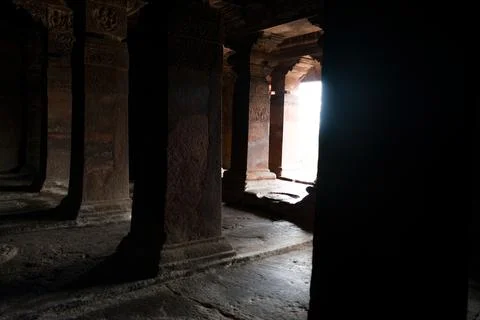 Badami cave temple interior look in the dark with beautiful decorated pilla.. Stock Photos