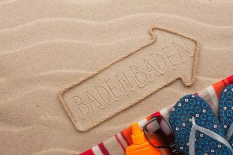 Baden Baden  pointer and beach accessories lying on the sand Stock Photos
