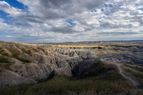 Badlands Canyon Landscape Under Dramatic Cloudy Sky in Badlands NP, South D.. Stock Photos