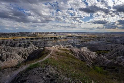 Badlands Canyon Landscape Under Dramatic Cloudy Sky in Badlands NP, South D.. Stock Photos
