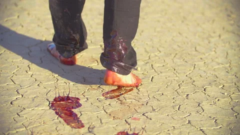 Badly wounded man stumbles through the desert and falls senseless Video stock 293113229