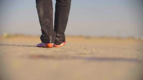 Badly wounded young man slowly walks through the scorched earth Stock Footage 293113228