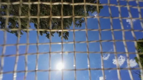 A badminton game, filmed from beneath the racket as the shuttlecock flies.SlowMo Stock Footage 336508237