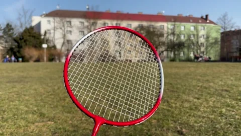 Badminton racket against the backdrop of a park Stock Footage 304609582