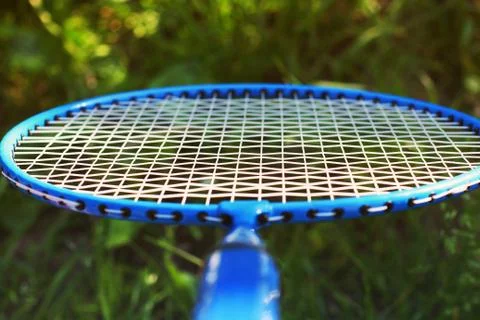Badminton racket close up on grass background Stock Photos