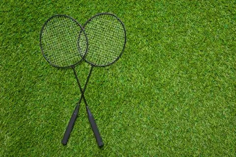 Badminton rackets lying on the grass Stock Photos