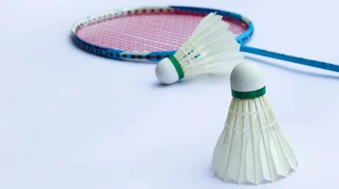 Badminton shuttlecocks with rackets on a white background symbolizing the s.. Stock Photos