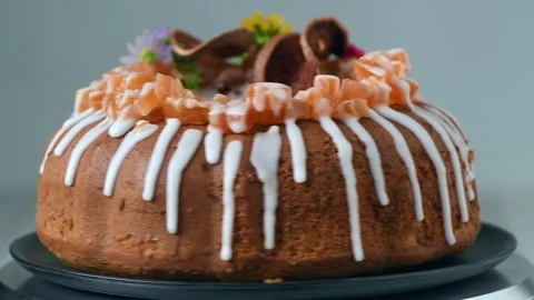 Bael Fruit Cake decorated with small flowers on top, Stock Footage 227543120