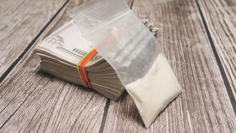 Bag of Cocaine With Stack of Money on a Table Stock Footage 88402799
