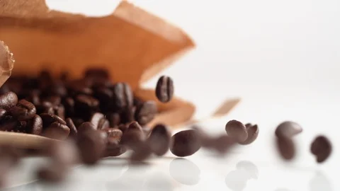 A bag of coffee beans falling onto a surface. Slow Motion. Stock Footage 121484839