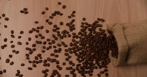 Bag falling and scattering coffee beans top view Slow motion Stock Footage 98266101