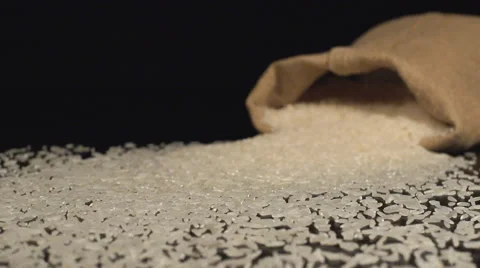 Bag falls on a table and a white rice scatter out it Video stock 59016704
