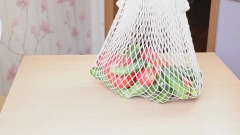A bag of fresh vegetables, cucumbers and tomatoes. Zhenzhina comes up to the Stock Footage 166003078