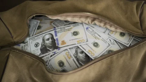 stuffing bag full of money cash on the r, Stock Video