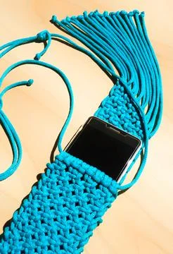Bag knitted with macrame technique for a mobile phone. Stock Photos